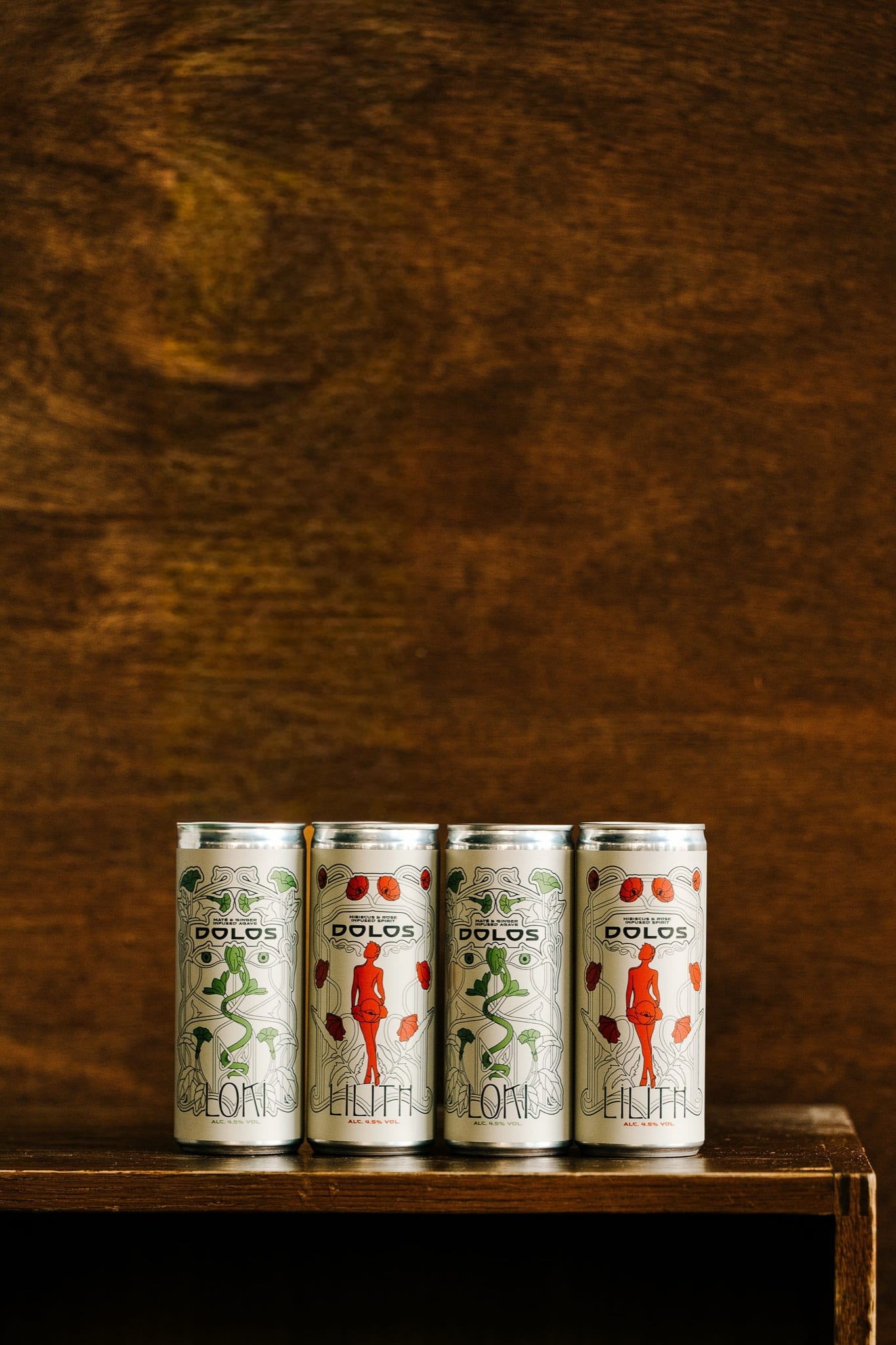 Four Dolos cans, Loki and Lilith, standing on a wooden shelf